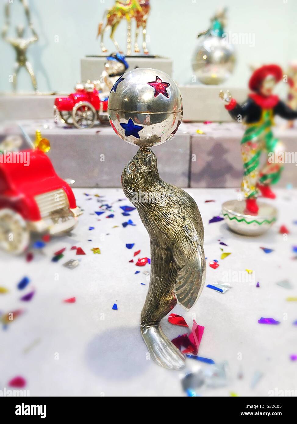 Miniature Tiffany Seal figurine balancing a ball in a circus display at Christie’s auction house in Rockefeller Center, NYC, USA - Smartphone Captured Stock Image
