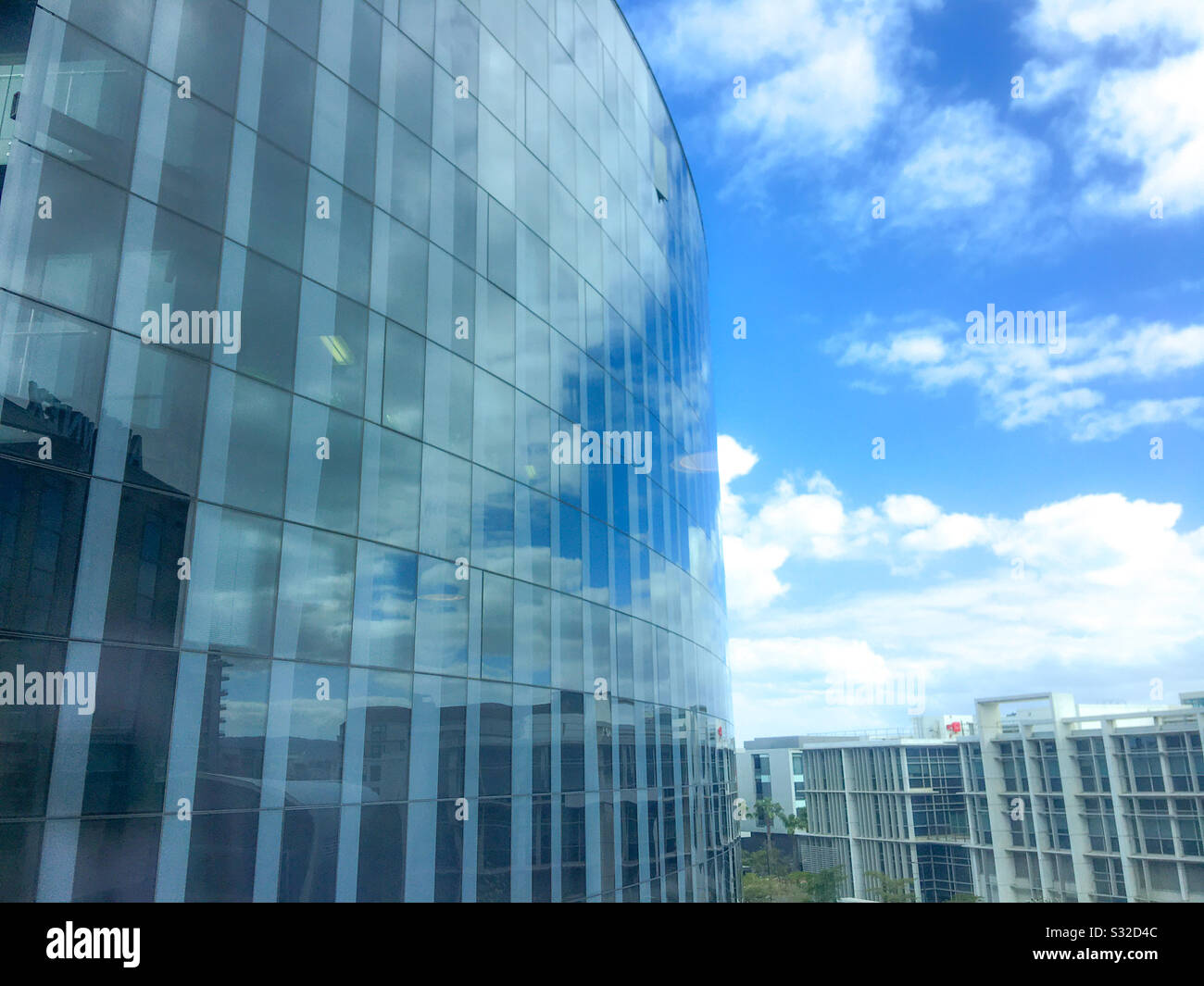 Blue sky reflections on glass building Stock Photo