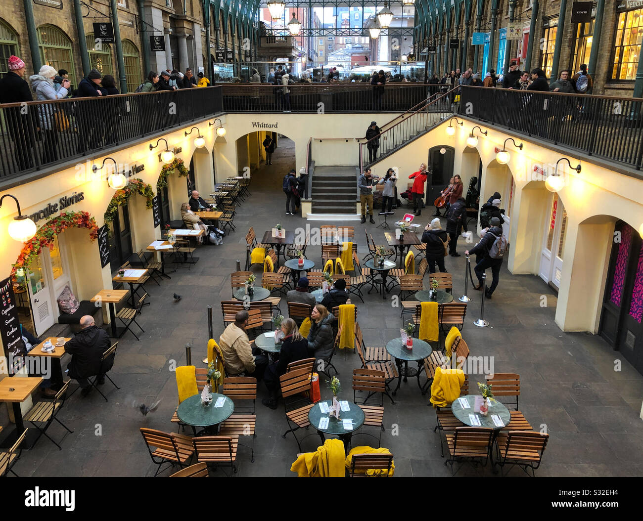 The South Hall, Covent Garden, with tourists, classical musicians busking and people at the cafe tables. London, England. Stock Photo