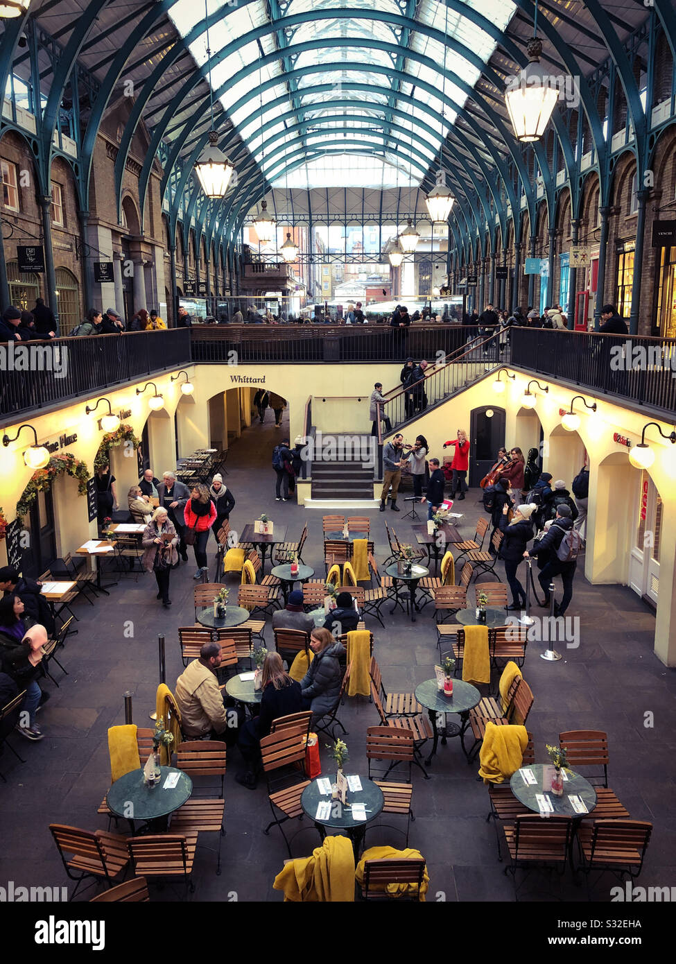 The South Hall, Covent Garden, with tourists, classical musicians busking and people at the cafe tables. London, England. - Smartphone Captured Stock Image