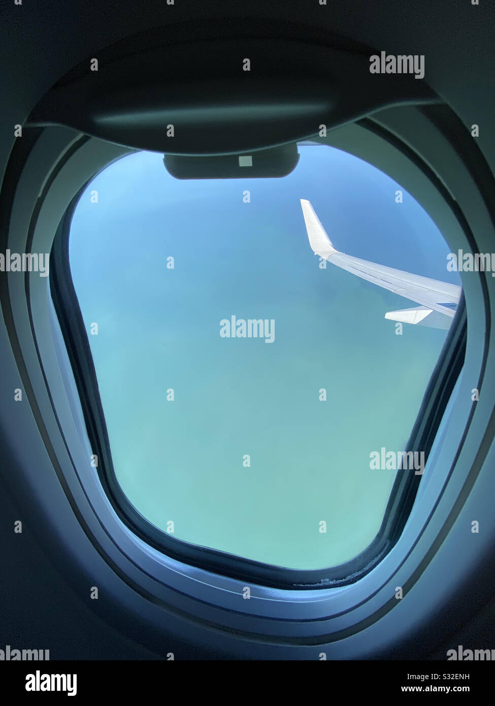 View of tropical water from airplane window - Smartphone Captured Stock Image