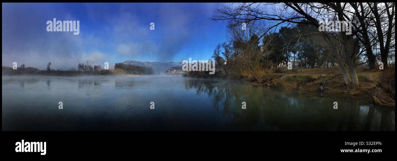 Fog rises from the River Ebro near the Garcia crossing, Catalonia, Spain. - Smartphone Captured Stock Image