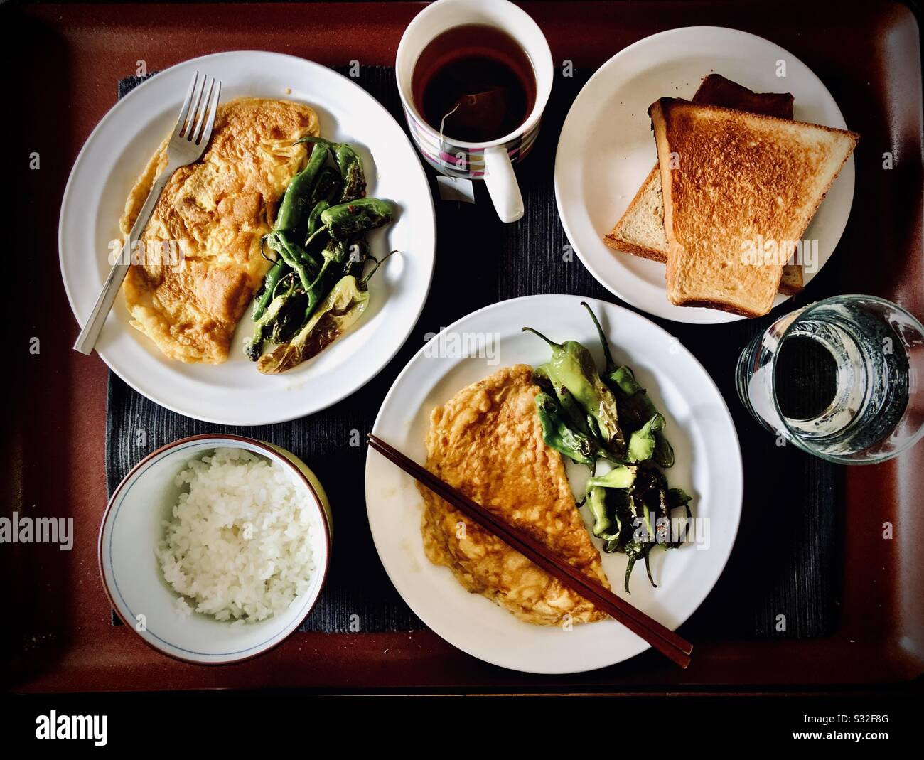Homemade vegetarian lunch with omelette, green peppers, rice, toast, tea - Smartphone Captured Stock Image