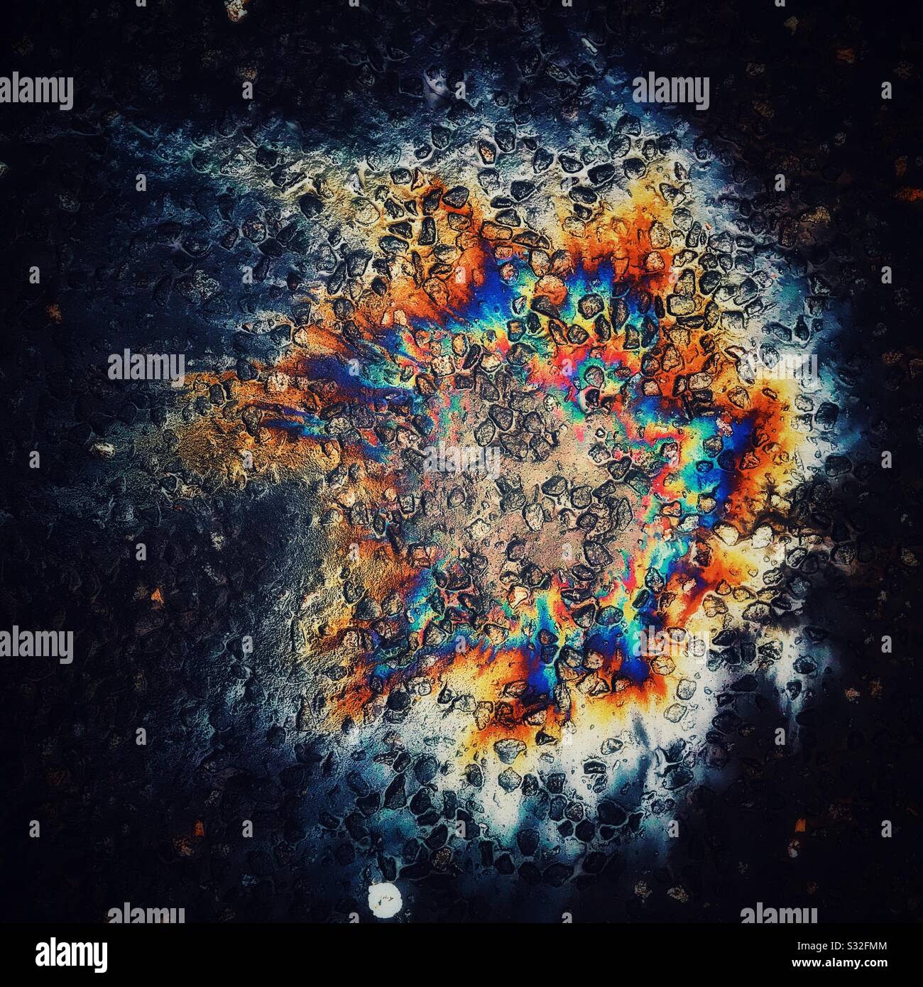 Interesting colours made by Oil spill on road. - Smartphone Captured Stock Image