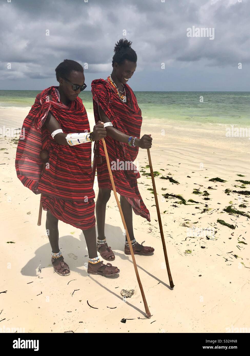 Masai warriors walking along the beach Stock Photo