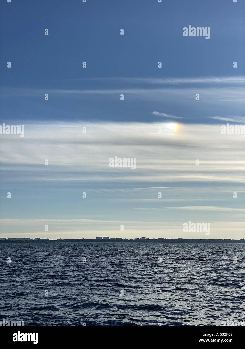 Iridescence in the skies over Gulf of Mexico water - Smartphone Captured Stock Image