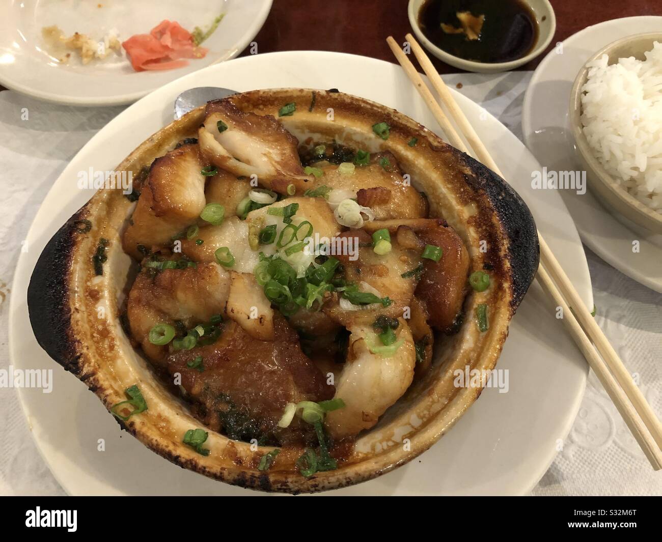 Asian dish baked in a pot of white fish and scallions. - Smartphone Captured Stock Image