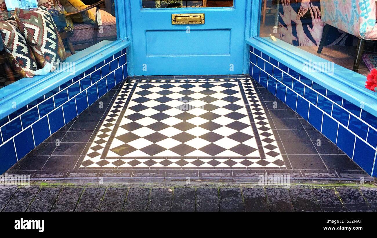 Black And White Patterned Floor Tiles And Blue Wall Tiles In The