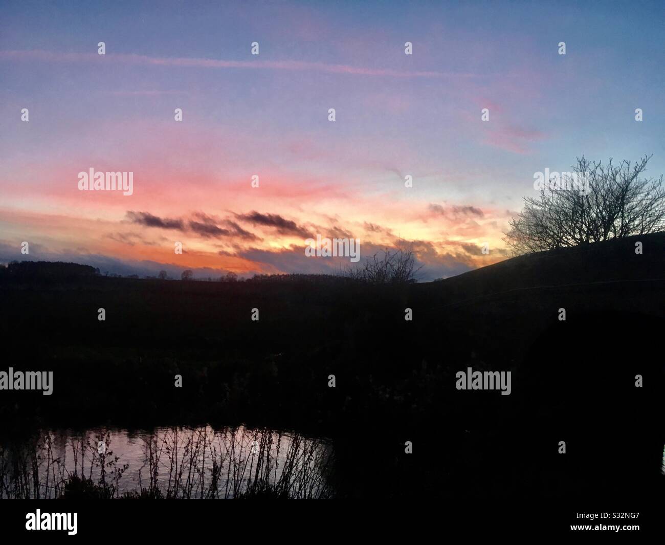 Sunset over waterlogged fields near Denton Reservoir and Grantham Canal Stock Photo