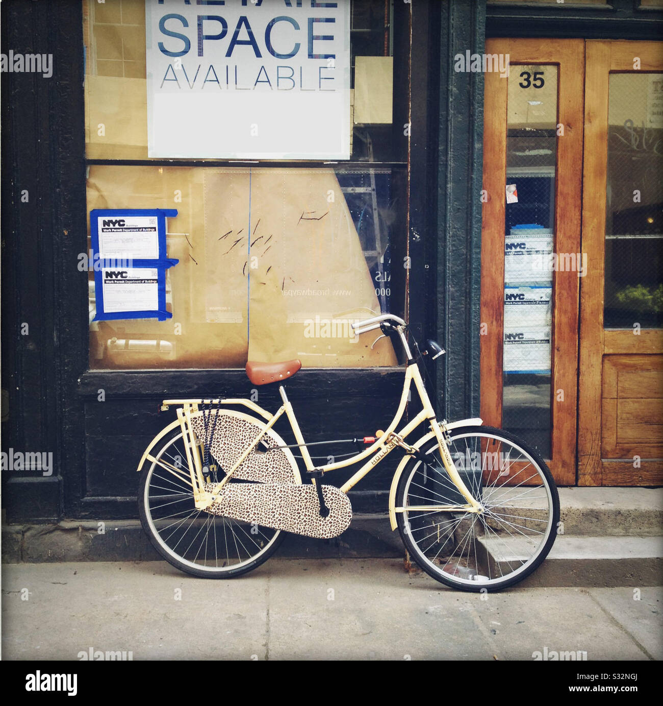 Cool bike parked in front of Space for Rent Stock Photo