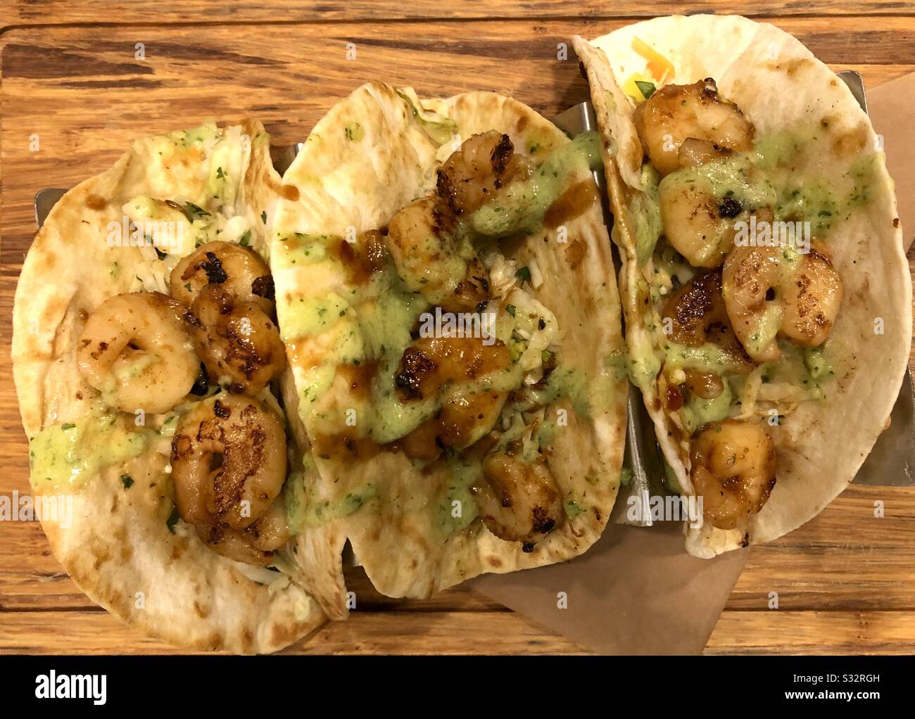 Shrimp tacos on a wooden board. - Smartphone Captured Stock Image