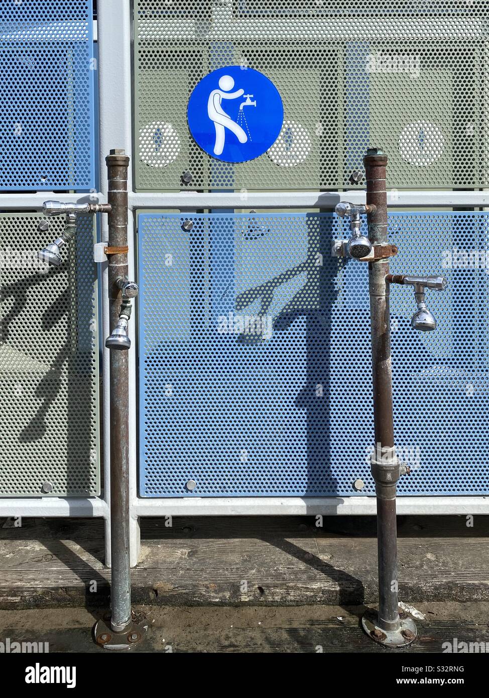 Outdoor public shower off area on California beach - Smartphone Captured Stock Image