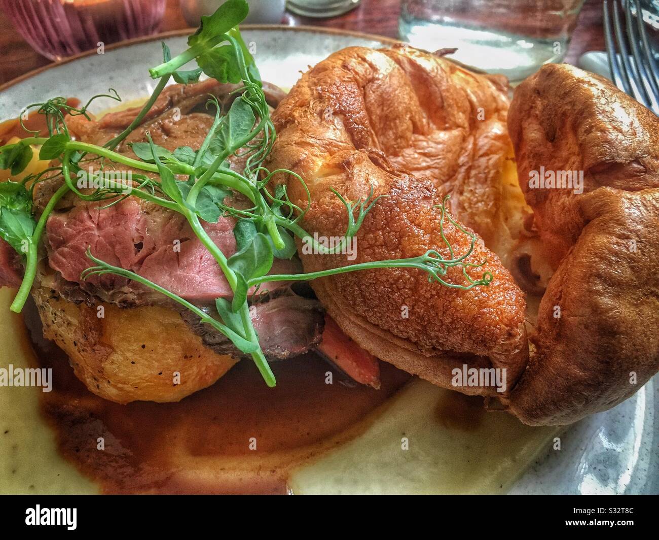 Posh Sunday Lunch; roast beef, Yorkshire pudding and a garnish of pea shoots. - Smartphone Captured Stock Image