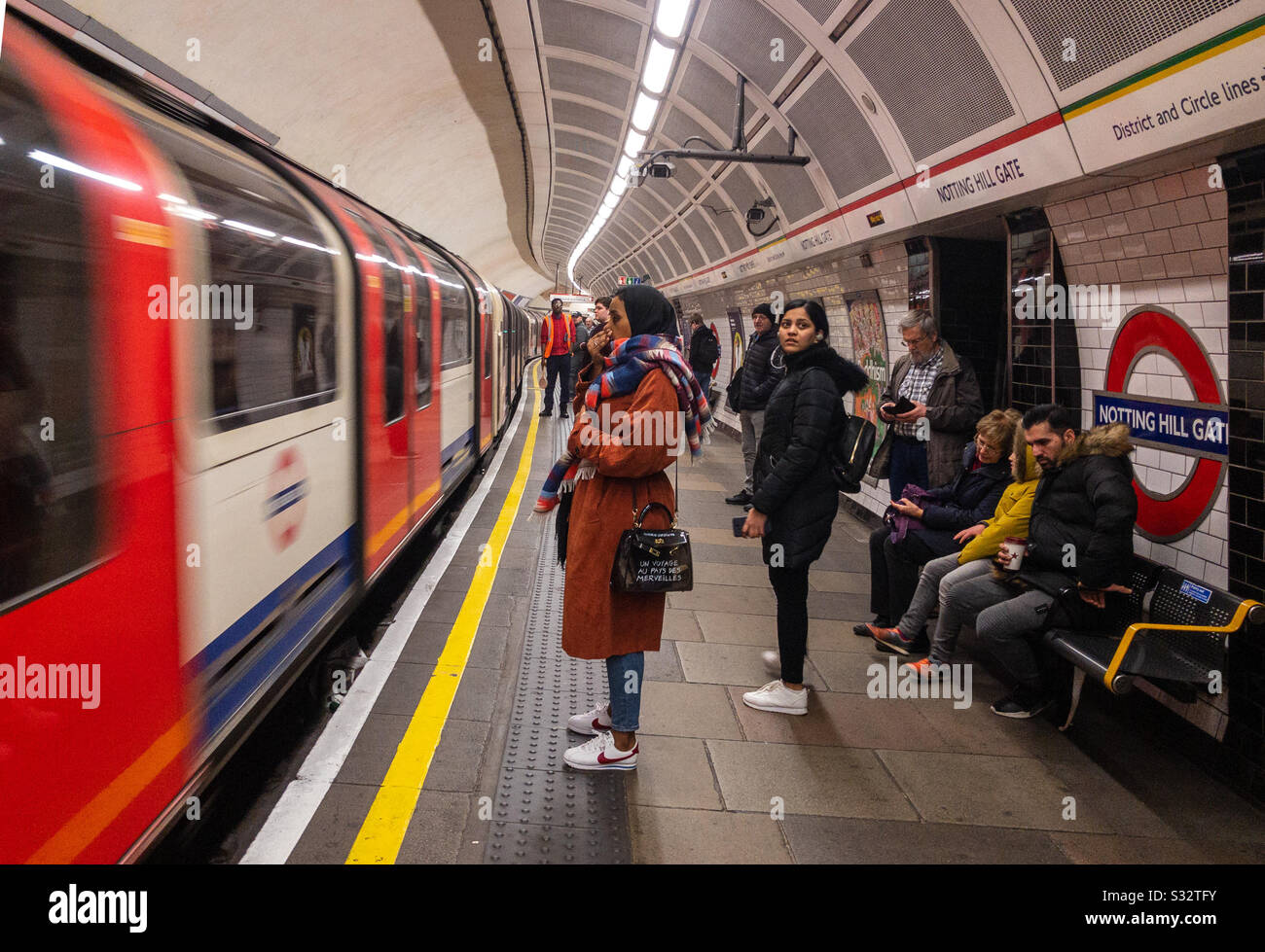 A lady waits to board a London Underground train which has just arrived at the station - Smartphone Captured Stock Image