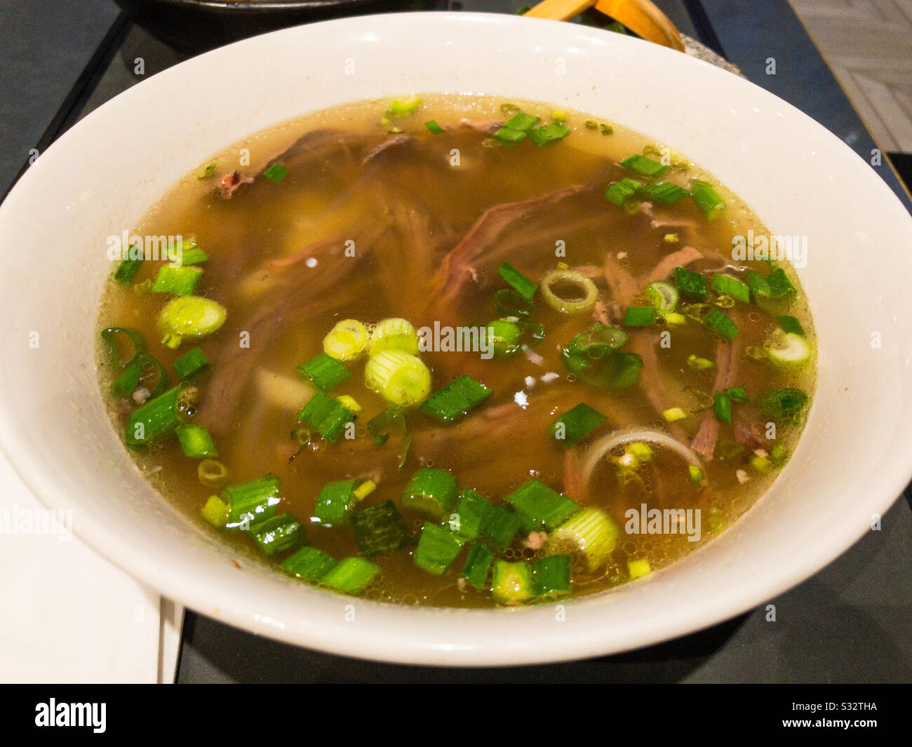 Bowl of Pho, a Vietnamese soup with noodles and beef brisket. - Smartphone Captured Stock Image