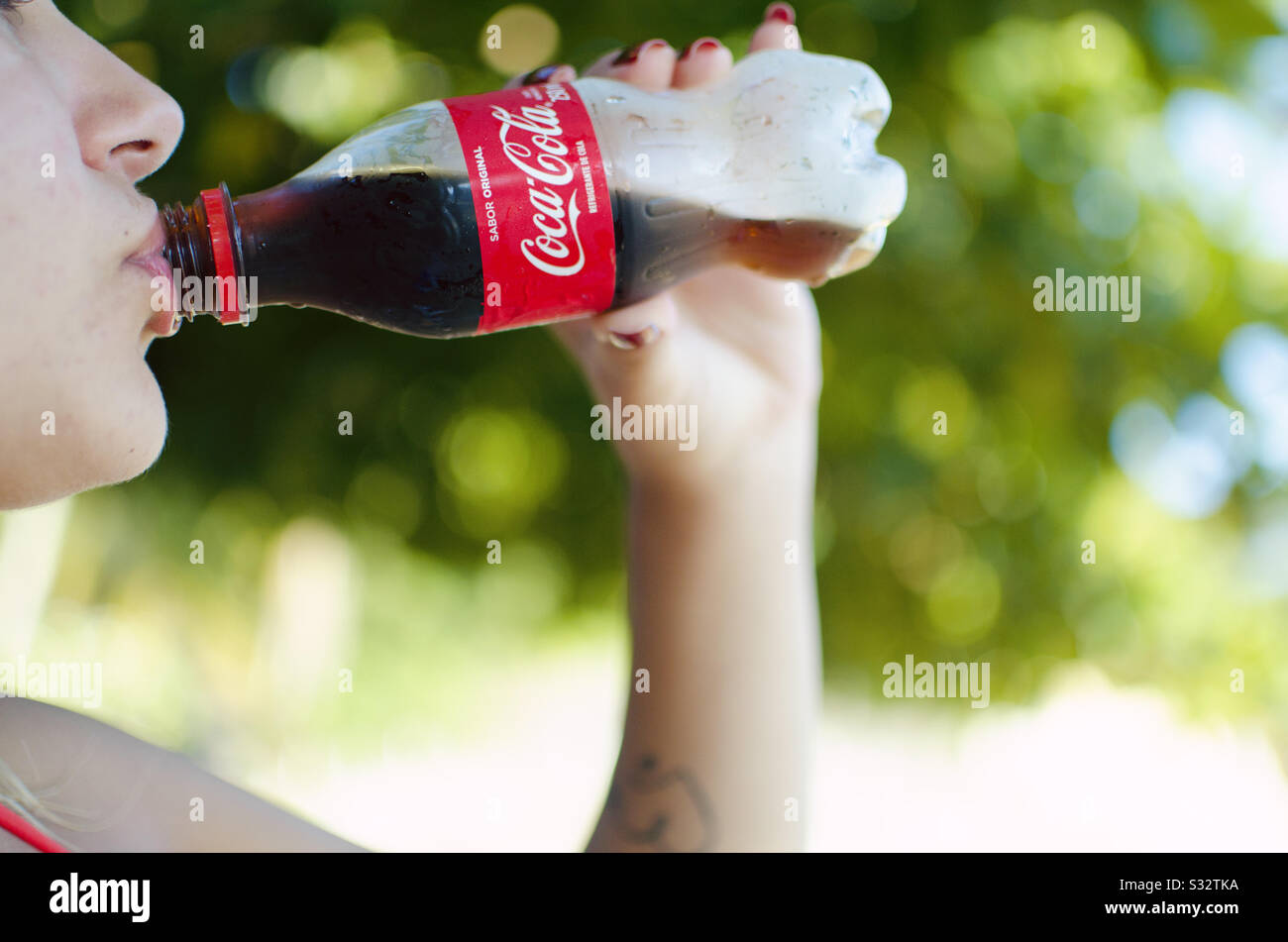 Woman drinking Coke Stock Photo Alamy