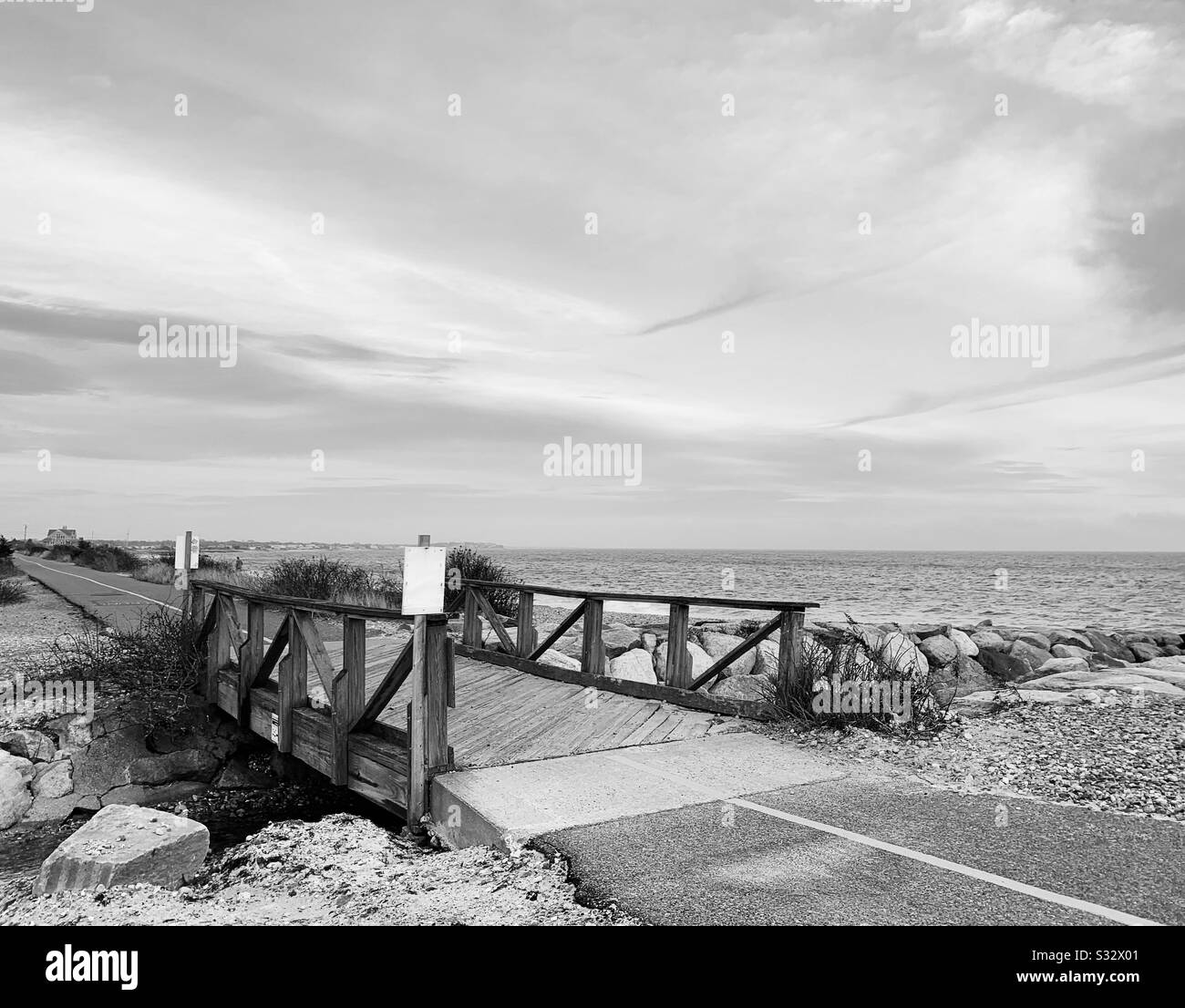 Black and white winter view of the Shining Sea Bikeway in Falmouth, Cape Cod, Massachusetts, United States - Smartphone Captured Stock Image