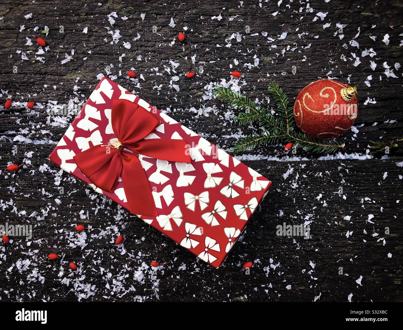 Christmas decorations: gift and red bauble - Smartphone Captured Stock Image