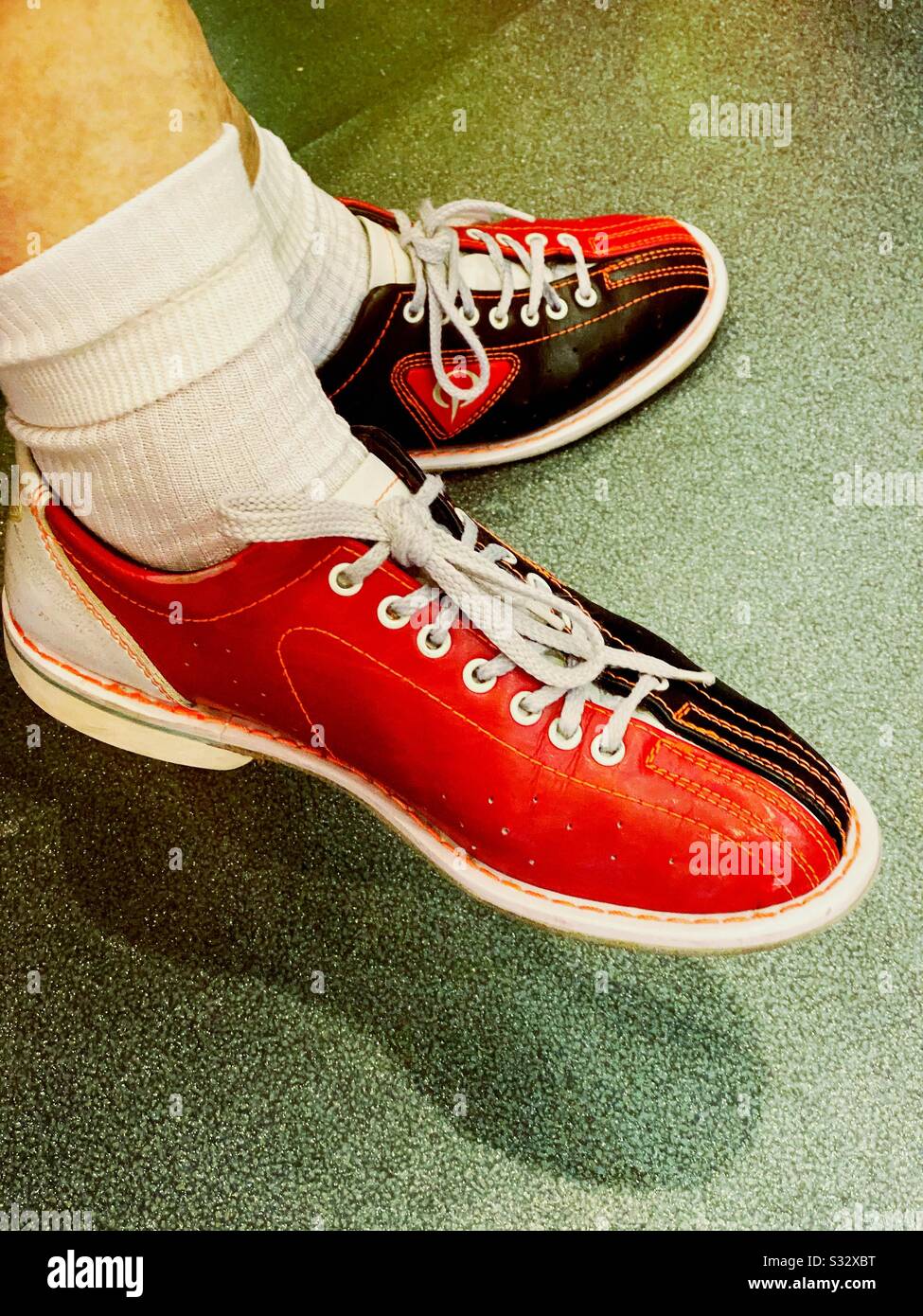 Close up of person wearing black and ten pin bowling shoes with white socks Stock Photo - Alamy