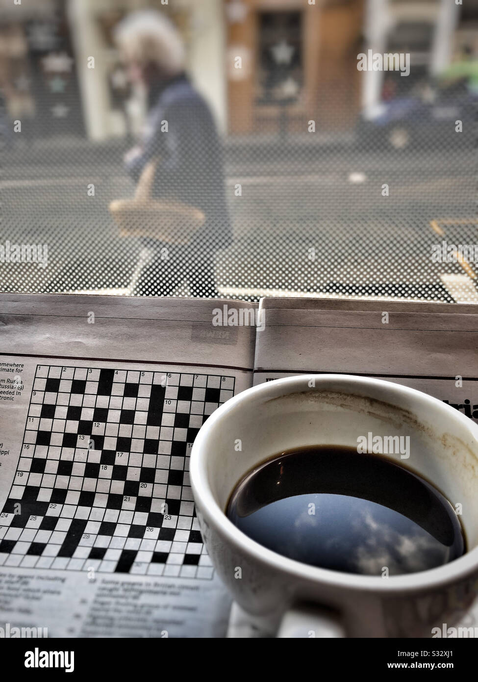 Coffee and crossword in the cafe - Smartphone Captured Stock Image