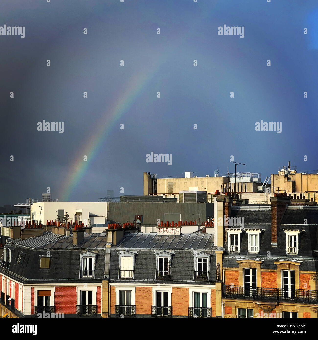 cloudy sky with rainbow in Paris, France - Smartphone Captured Stock Image