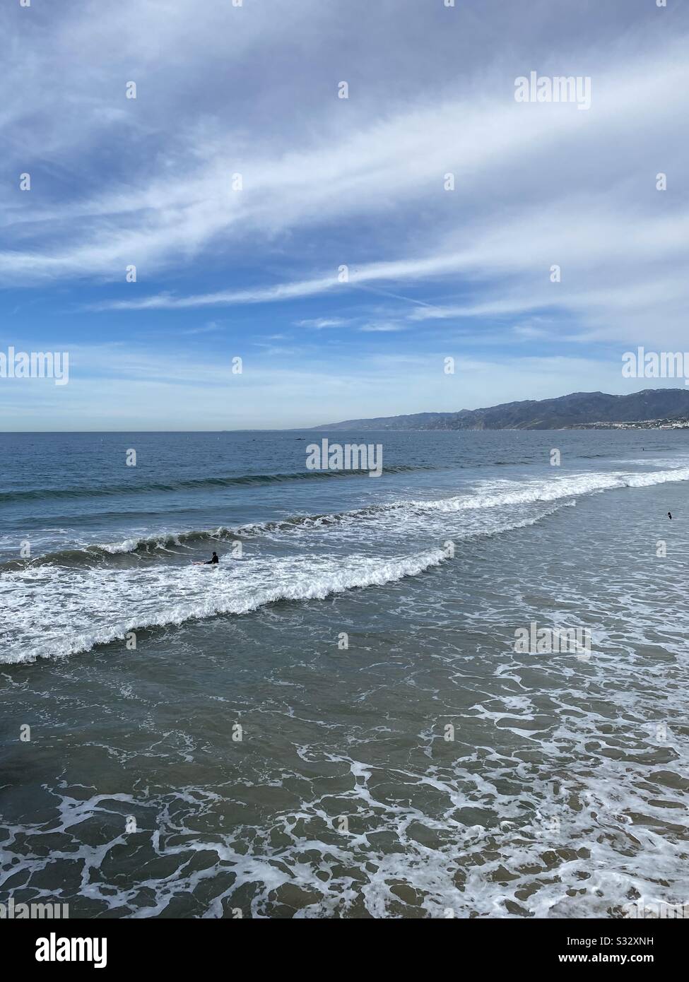 Blue Pacific Ocean water with mountains in the distance - Smartphone Captured Stock Image