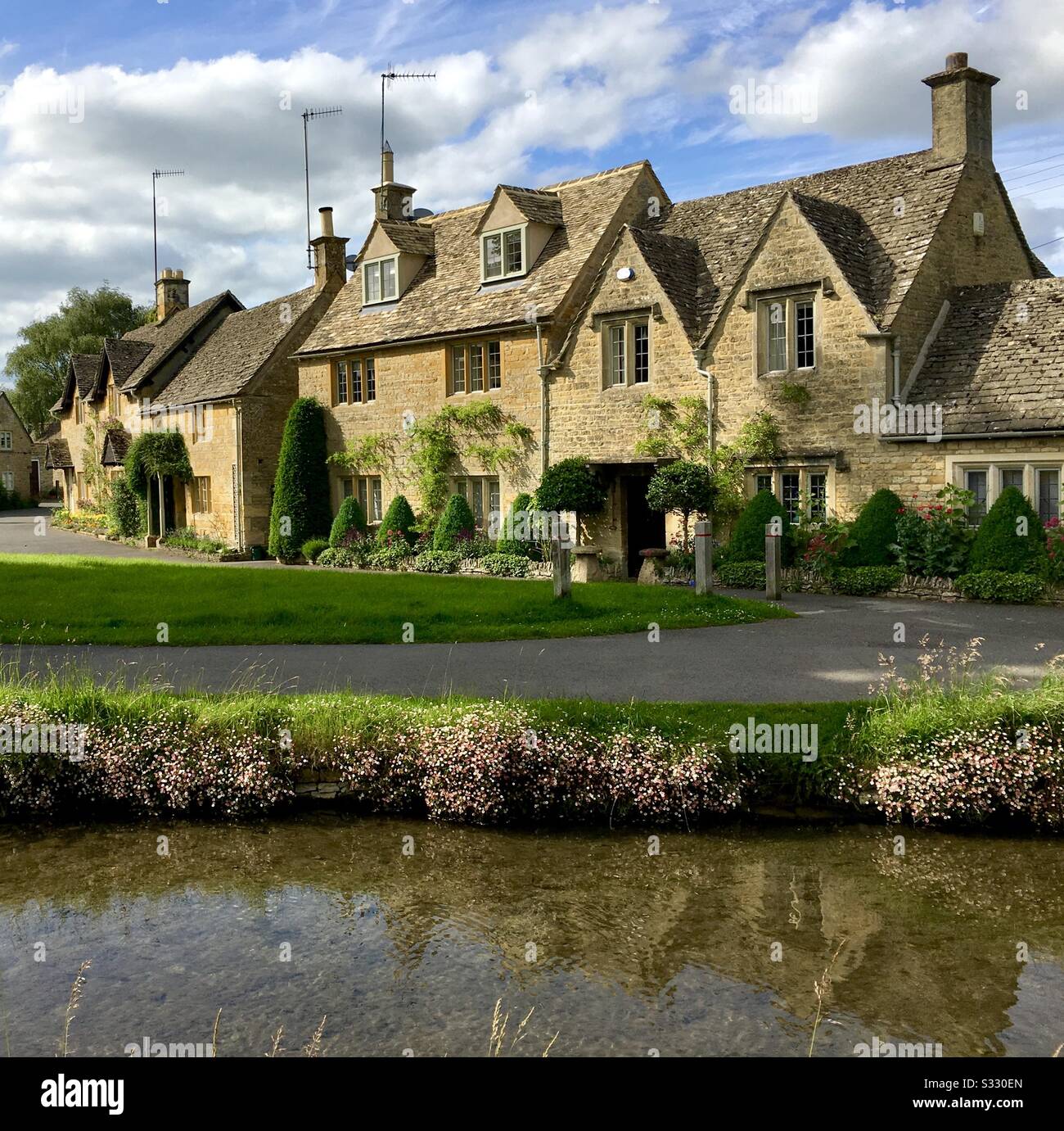 A view of cottages in Lower Slaughter in the Cotswolds Gloucestershire - Smartphone Captured Stock Image