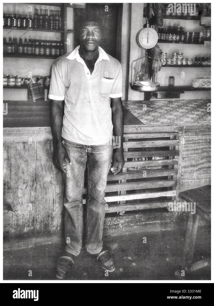 A man standing in a rural Jamaica store. - Smartphone Captured Stock Image