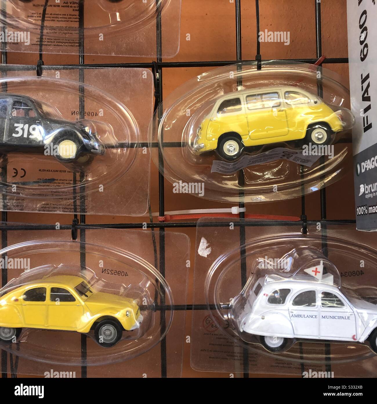 Toy die cast model cars displayed at newsstand Bologna Italy - Smartphone Captured Stock Image