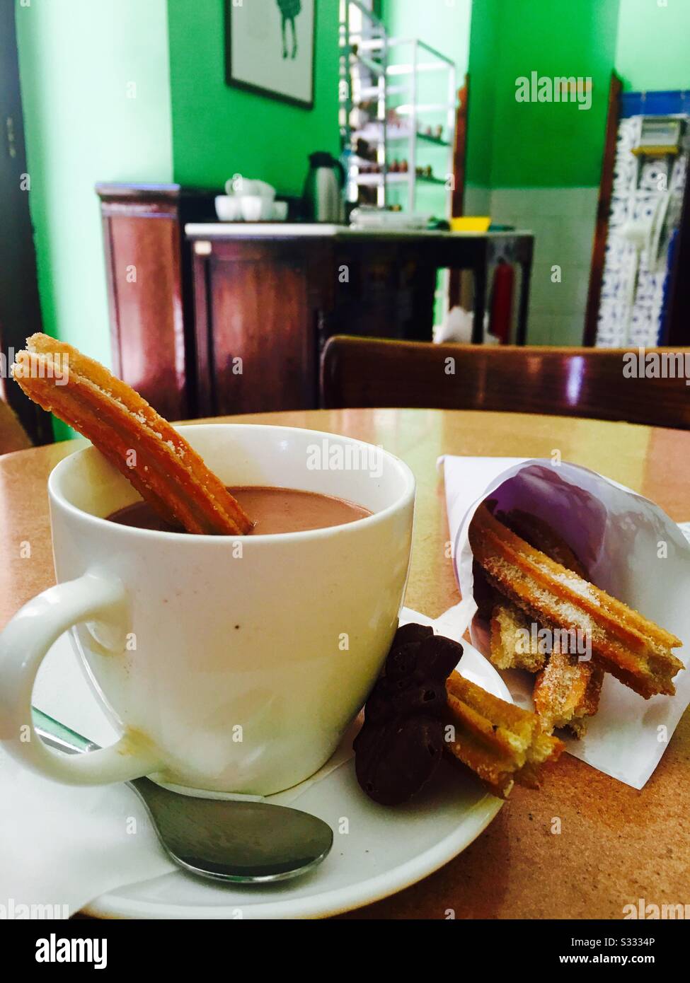 Churros and a cup of hit chocolate. - Smartphone Captured Stock Image