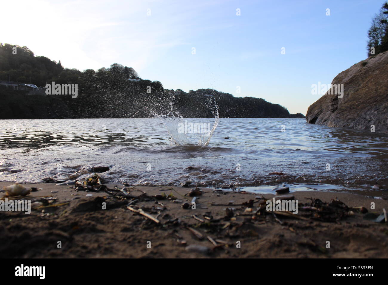 Skimming stone splash in the sea Stock Photo