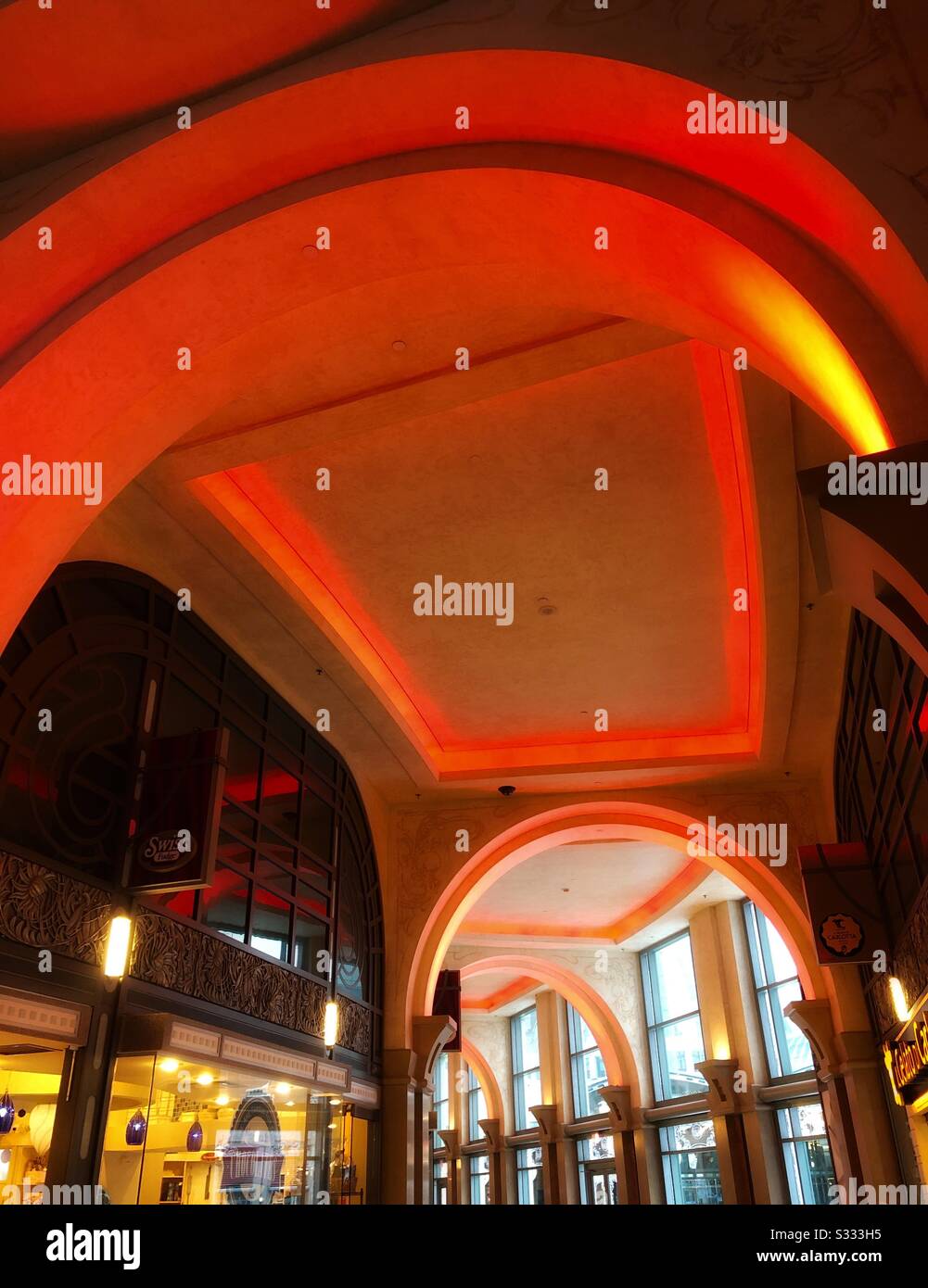 Arched walkway illuminated in red. Stock Photo