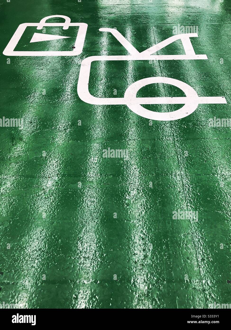 Car parking space reserved for owners of electric or hybrid vehicles who wish to charge their cars whilst they go shopping. Stock Photo