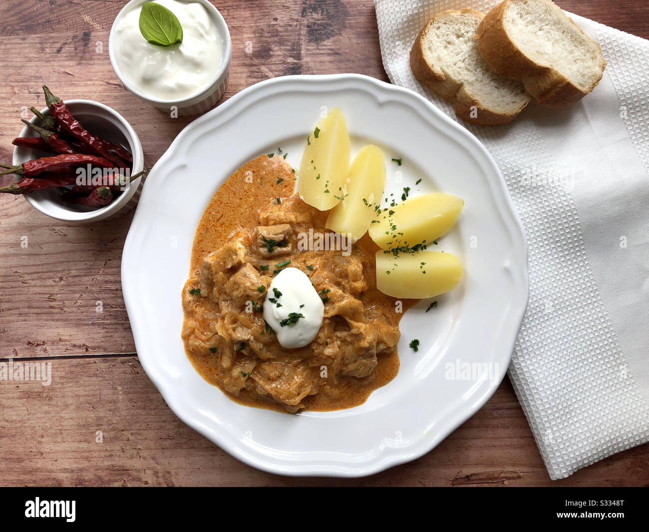 Hungarian specialty Szegedin goulash with sour cabbage and boiled potatoes. Stock Photo