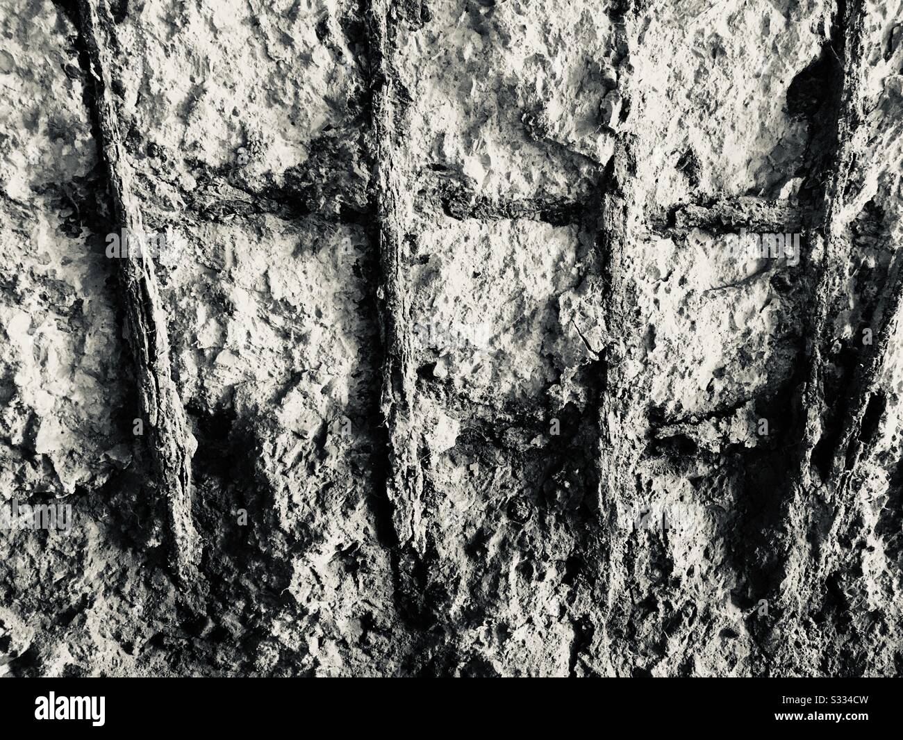 Crumbling concrete wall with steel wire reinforcements - Smartphone Captured Stock Image