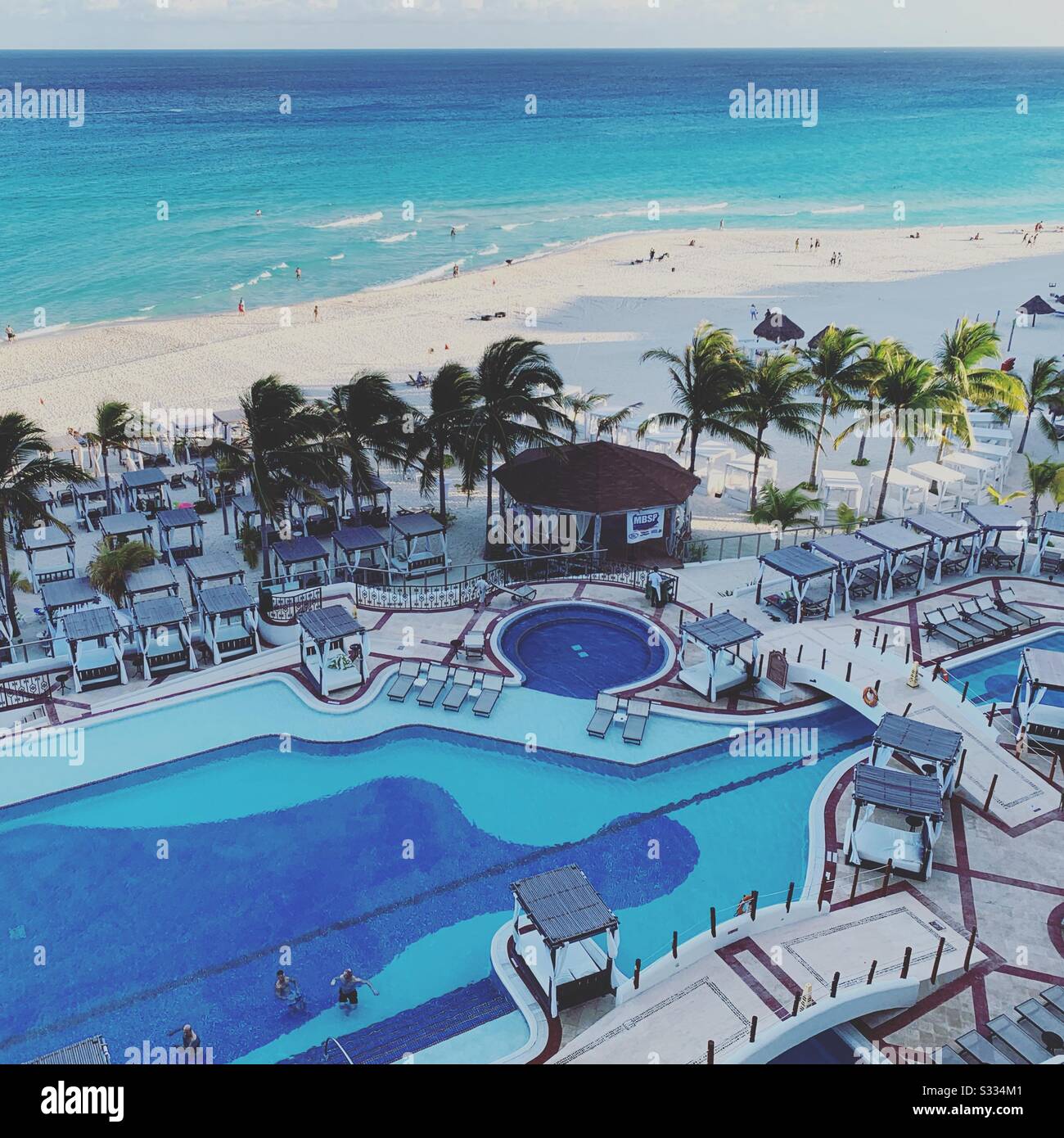 View from a sixth-floor balcony of the pool and beach at Hyatt Zilara, Cancun, Mexico - Smartphone Captured Stock Image