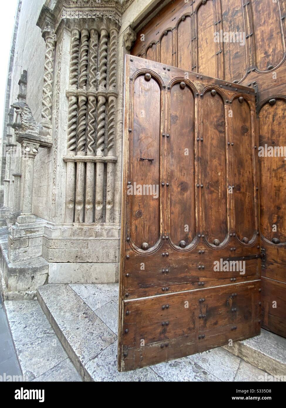 Old wooden church door, San Francesco, Ascoli Piceno, Marche region, Italy - Smartphone Captured Stock Image