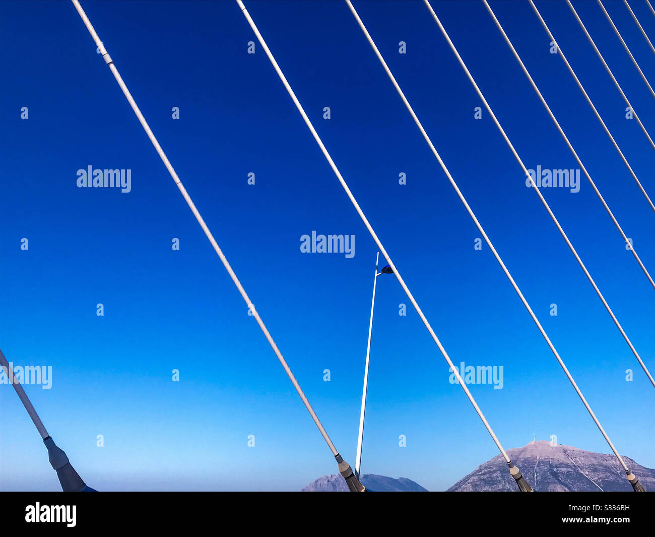 Diagonal suspension bridge cables and blue sky Stock Photo