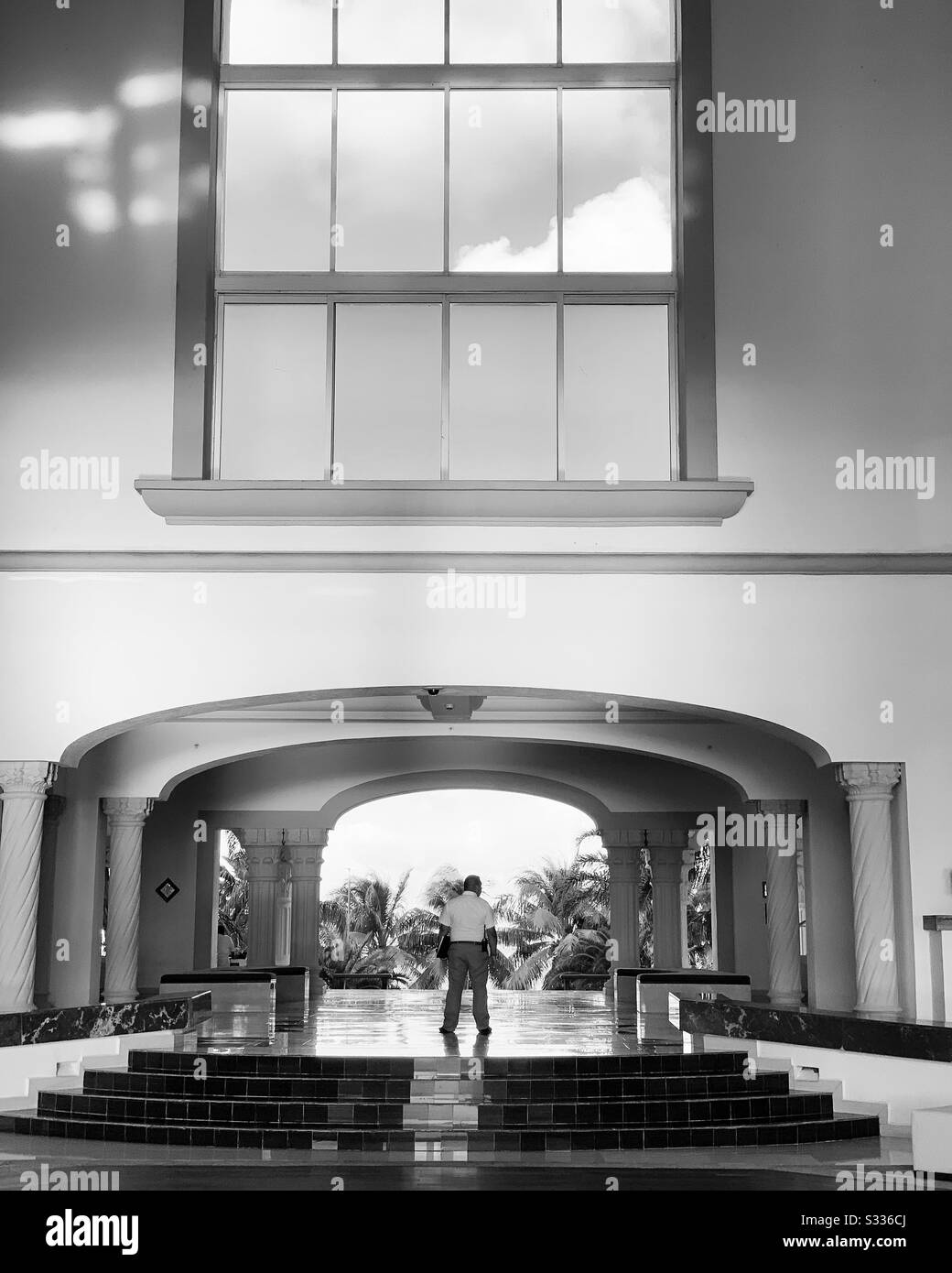 Black and white image facing toward the street from the open-air lobby at the Hyatt Zilara Hotel, Cancun, Quintana Roo, Mexico - Smartphone Captured Stock Image