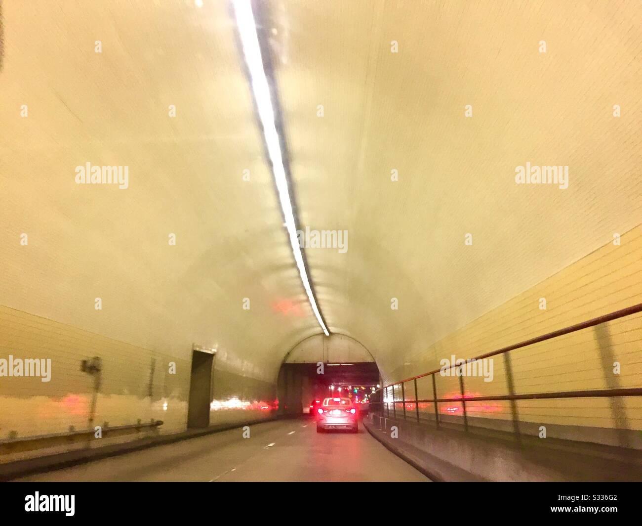 Pick up truck with brake lights in Broadway Tunnel, San Francisco. Yellow tunnel between Russian Hill and Nob Hill. - Smartphone Captured Stock Image
