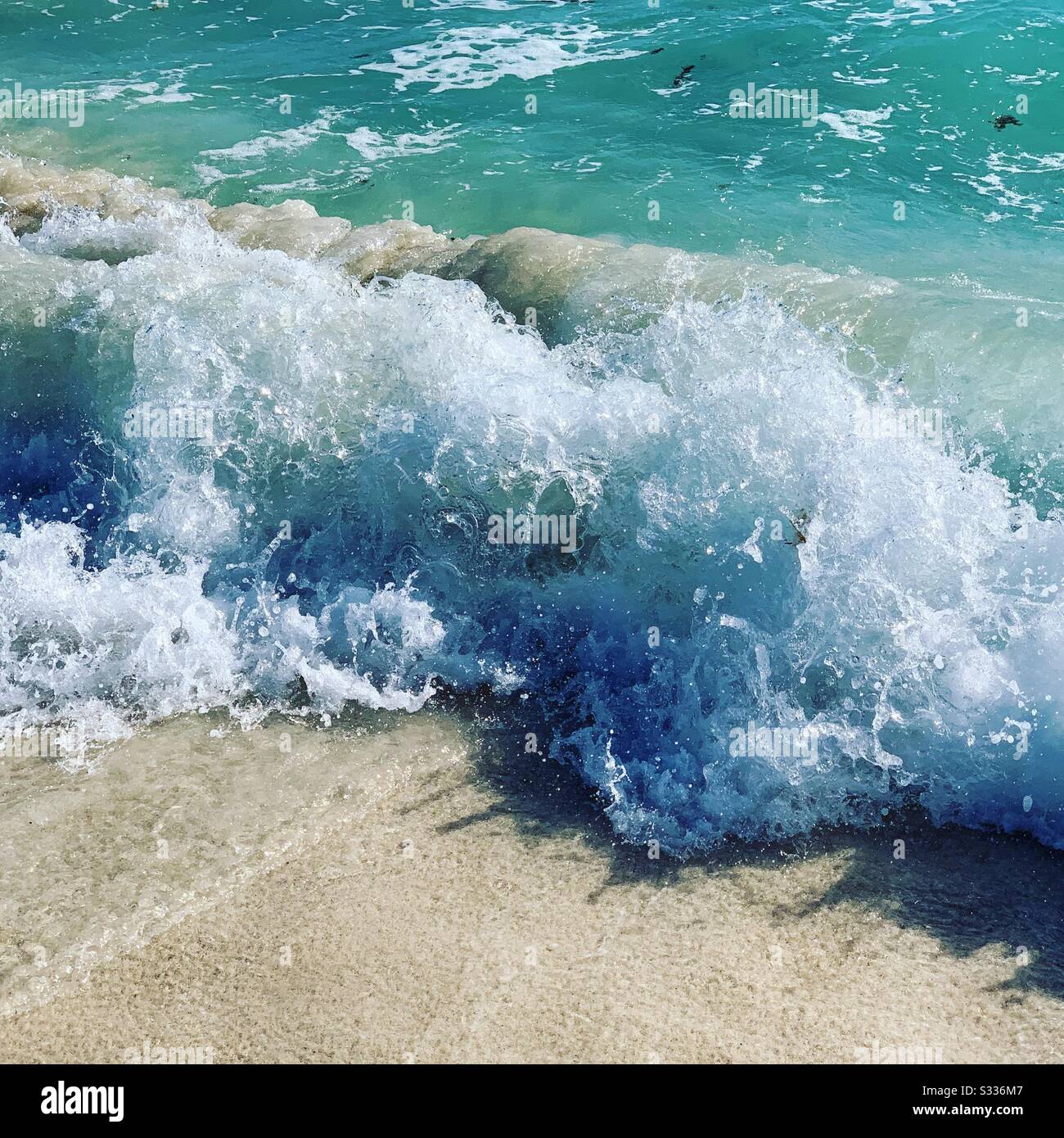 Wave crashing on a beach in Cancun, Quintana Roo, Mexico - Smartphone Captured Stock Image
