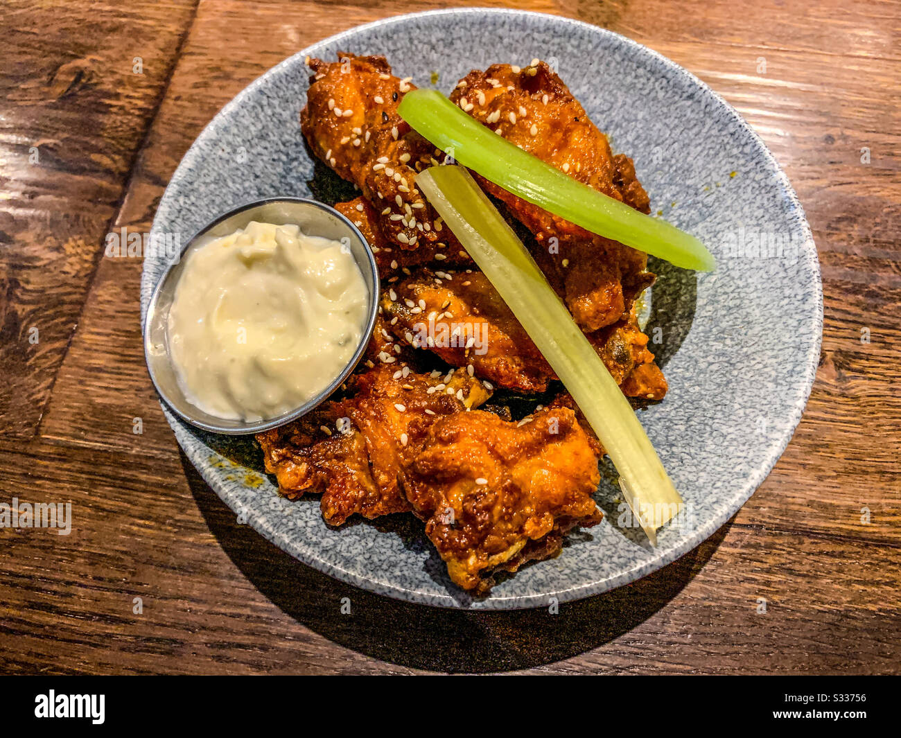Spicy chicken wings with blue cheese sauce and celery sticks Stock Photo