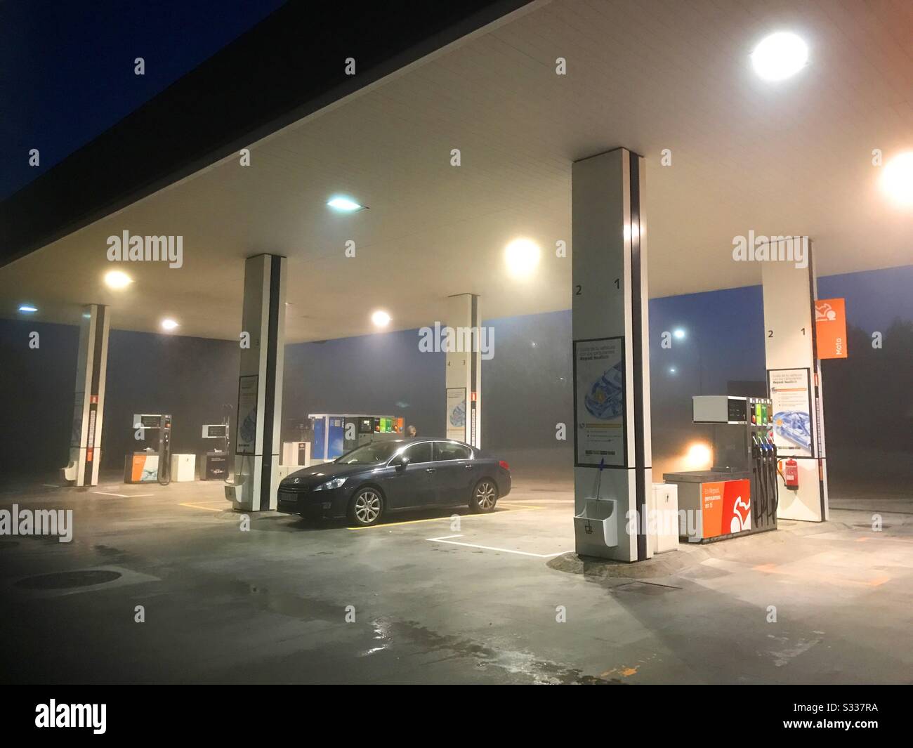 Car refuelling at gas station in the mist. - Smartphone Captured Stock Image