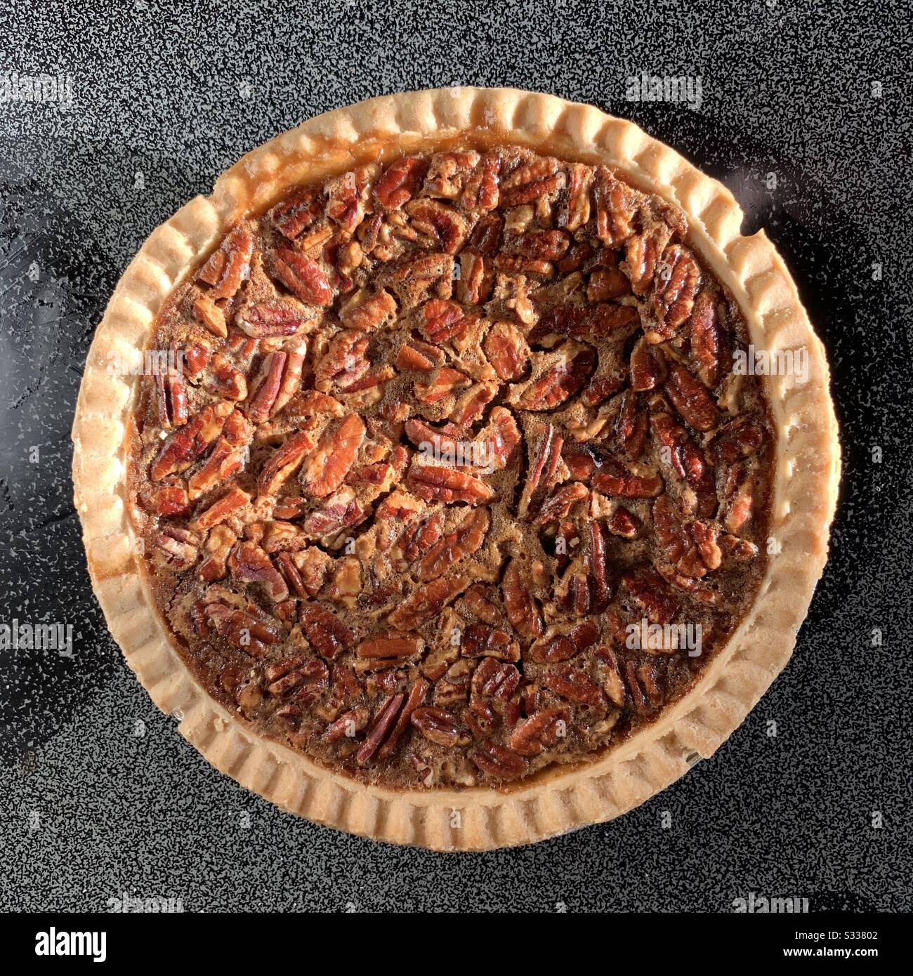 Gluten free pecan pie top view sitting on stove pecan pie - Smartphone Captured Stock Image