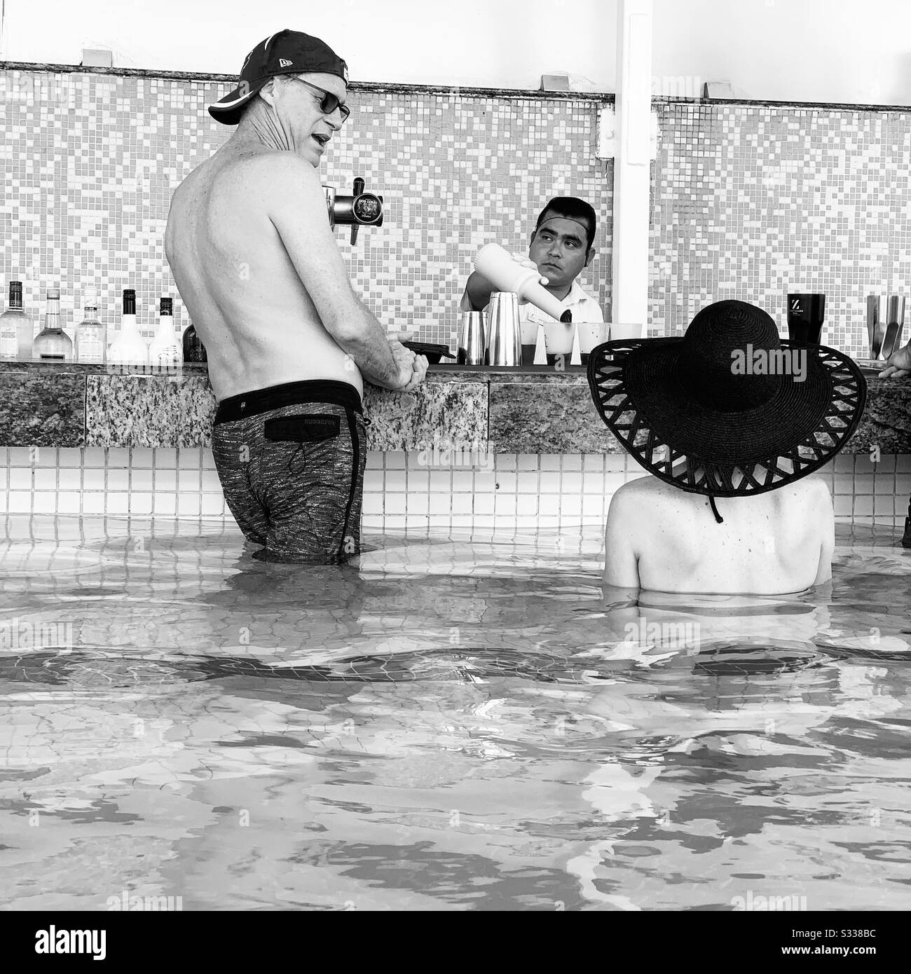 Black and white image of people at the swim-up bar, Hyatt Zilara, Cancun, Quintana Roo, Mexico Stock Photo