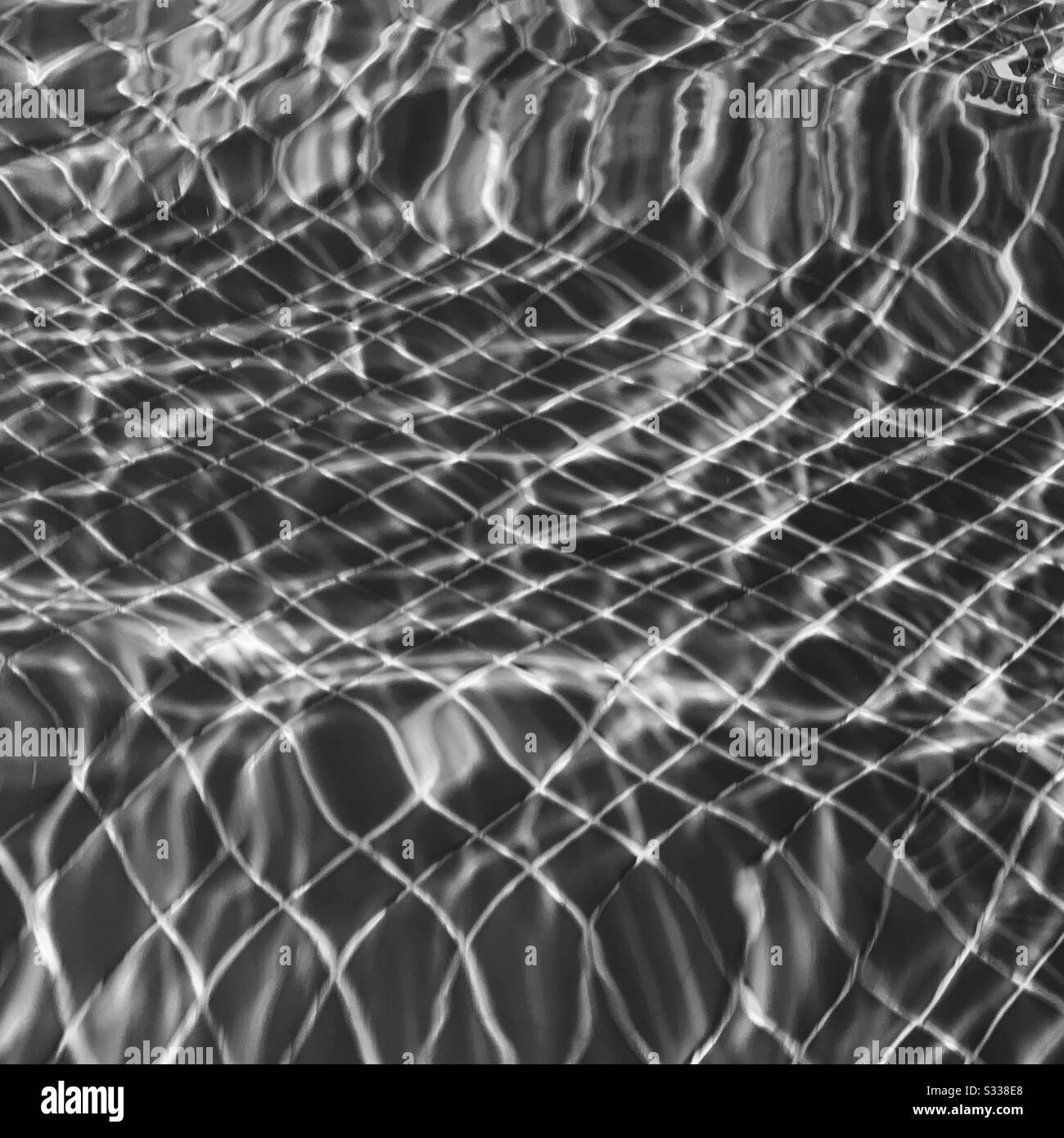 Black and white image of sunlight on a swimming pool Stock Photo - Alamy