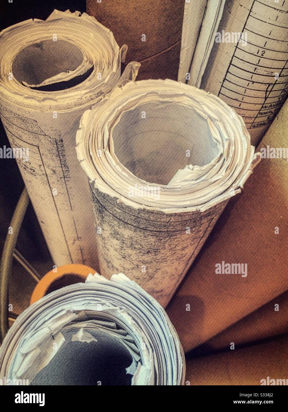 Vintage roles of blueprints in an architects office, USA - Smartphone Captured Stock Image