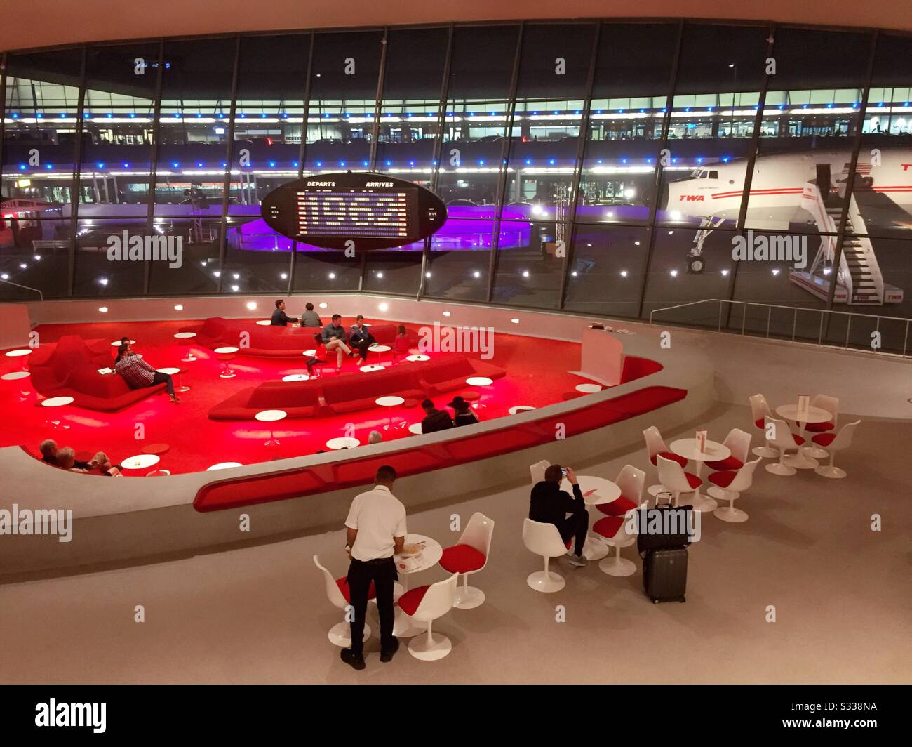 People enjoying cocktails in the sunken lounge in the heart of the TWA hotel, JFK, NYC, USA - Smartphone Captured Stock Image