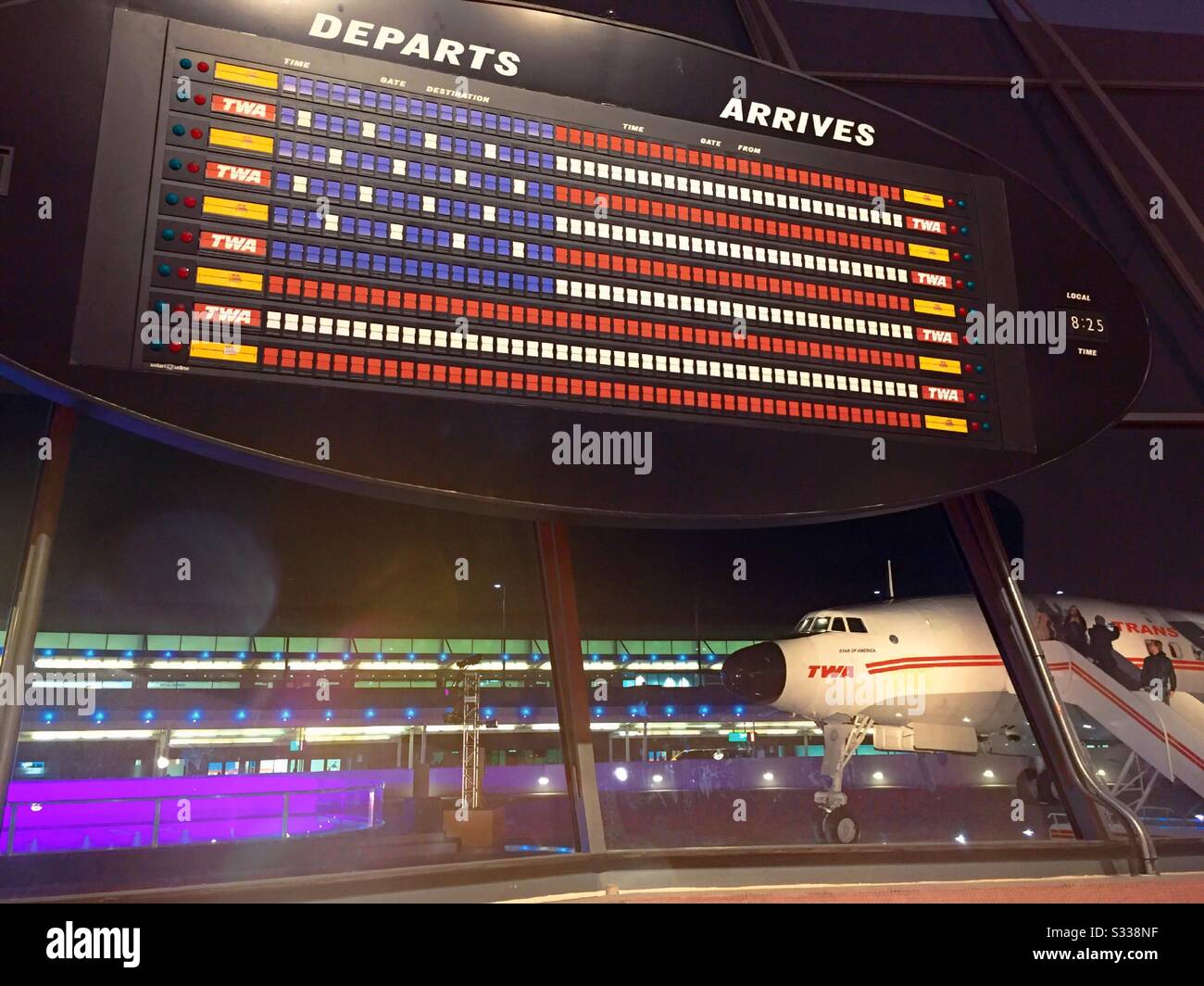 The departure and arrival board in the sunken lounge is configured in an American flag, TWA Hotel, JFK, New York City, USA - Smartphone Captured Stock Image