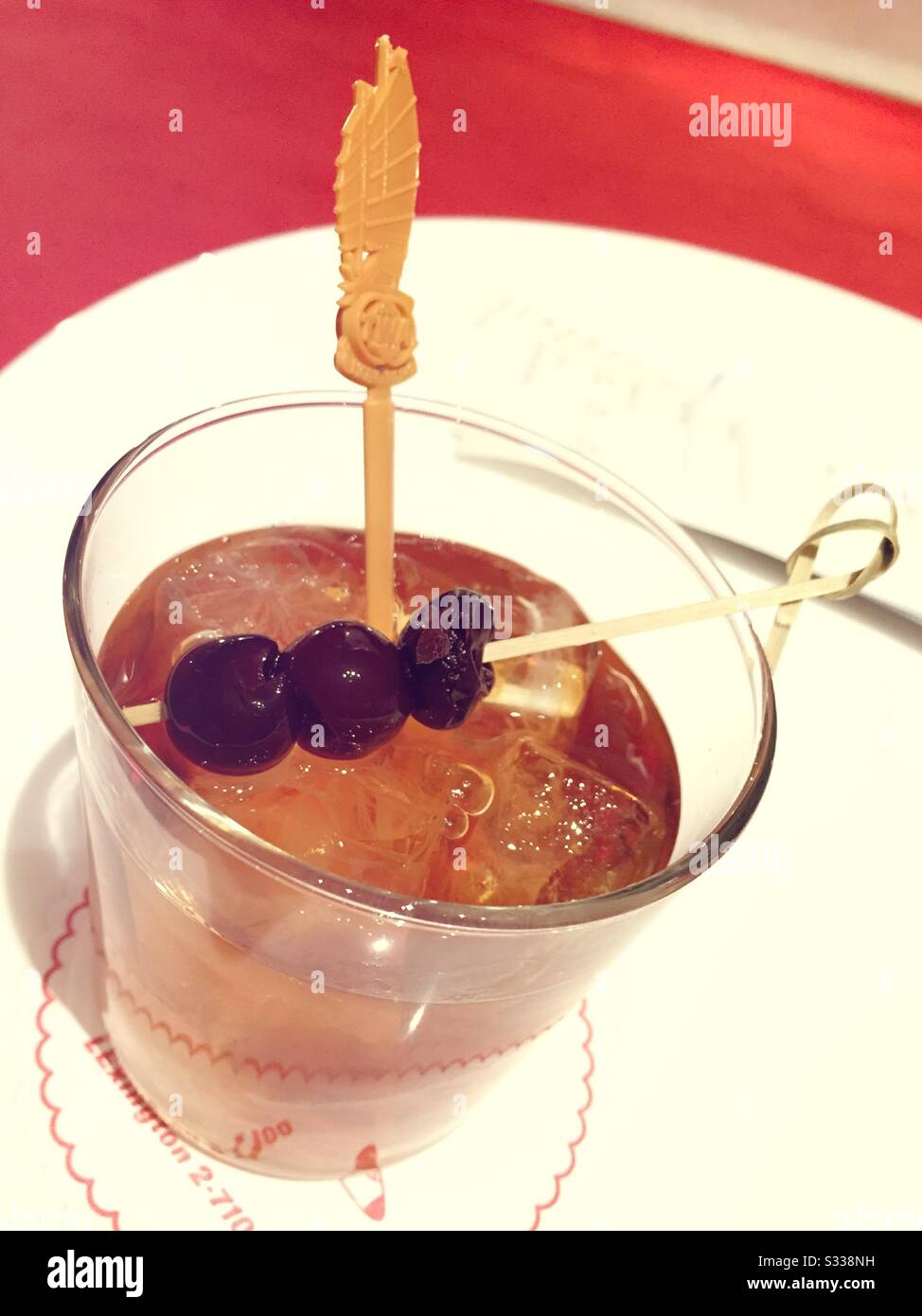 An old fashion cocktail with cherries served at the TWA hotel cocktail  lounge, JFK airport, NYC, USA Stock Photo - Alamy